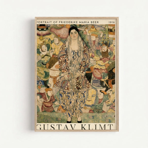 A framed reproduction print of Gustav Klimt's 1916 portrait showing a woman with long dark hair wearing an ornate patterned robe, surrounded by colorful decorative figures and mystical characters in Klimt's distinctive Art Nouveau style. The artwork features rich golds, greens, and earth tones with intricate patterns and symbolic imagery. The print is displayed in a light wooden frame against a white wall.