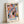 May include: Framed abstract art poster with colorful geometric shapes in pink, blue, orange, yellow, and black on white background, with "MATISSE" text at bottom. Light wood frame leaning against white wall, showing modern minimalist home decor styling.