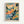 Colorful abstract landscape painting in light wood frame hanging on white wall. Features vibrant brushstrokes in blues, oranges, greens, and yellows depicting Mediterranean hillside with cypress trees and buildings. Fauve-style artwork with bold, expressive colors and loose painterly technique. Bottom shows French text and artist signature.