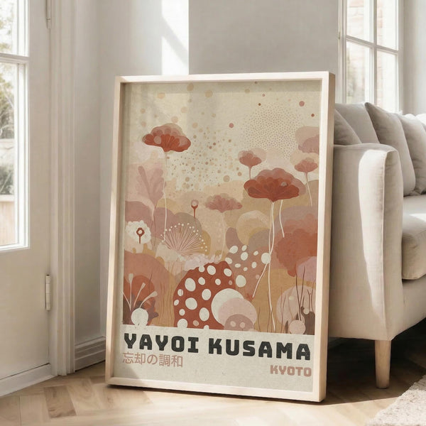 May include: Framed art print leaning against white wall next to beige sofa in bright living room. Abstract botanical illustration features coral, peach and cream colored mushrooms, flowers and organic shapes with polka dot patterns. Japanese text appears at bottom. Natural wood frame, approximately 2-3 feet tall, positioned on light wooden floor near windows with natural lighting.