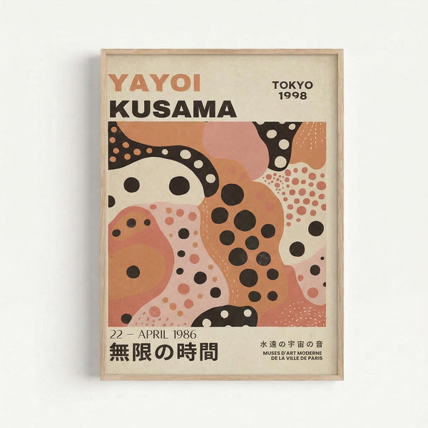 Framed exhibition poster featuring abstract artwork with flowing organic shapes in coral, peach, and cream colors, dotted with black and white polka dot patterns. The poster displays "YAYOI KUSAMA" in large text at the top, "TOKYO 1998" in the upper right, and "22 - APRIL 1986" with Japanese characters below the artwork. Light wood frame mounted on white wall.