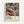 Framed abstract art poster featuring swirling, flowing forms in vibrant colors including orange, purple, blue, and cream. The dynamic composition shows organic shapes with polka dots and circular patterns reminiscent of cosmic or underwater scenes. Text at bottom reads "YAYOI KUSAMA" with Japanese characters and "Musée d'Art Moderne de la Ville de Paris." Light wood frame against white wall background.
