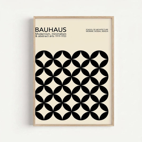 Framed minimalist poster featuring a geometric pattern of black circles arranged in a grid, creating white diamond shapes in the negative space. The cream-colored poster displays "BAUHAUS" text at the top with "Modernism, minimalism & abstract arts 1919-1933" and "SCHOOL OF ARCHITECTURE WEIMAR, DESSAU, BERLIN" in smaller text. The artwork is displayed in a light wood frame against a white wall background.