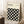 May include: A framed poster with cream background featuring black geometric circles in an overlapping pattern, creating four-pointed star shapes between them. Text reads "BAUHAUS Modernism, minimalism & abstract arts 1919-1933" and "SCHOOL OF ARCHITECTURE WEIMAR, DESSAU, BERLIN." The wooden-framed artwork leans against a white wall near a beige armchair, with a coffee cup on a wooden side table and soft natural lighting.