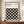 May include: Framed modernist poster with black geometric circle pattern on cream background, displayed on wooden sideboard with small white ceramic vase and books, against white wainscoted wall. The minimalist design features repeating overlapping circles creating diamond shapes between them.