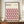 May include: Framed Bauhaus-style poster with geometric cube pattern in pink, orange, black and cream colors displayed on wooden sideboard. Modern minimalist artwork in brown frame alongside white ceramic vase and stacked books in neutral room setting with white paneled walls.