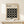 May include: Framed Bauhaus modernist poster with black background and white circle pattern arranged in grid, displayed on light wood console table beside small wrapped gift with greenery, against cream wall in minimalist room setting