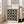 May include: Framed Bauhaus poster with black background and cream-colored circles arranged in a 4x4 grid pattern, leaning against white wall next to beige upholstered chair. Poster features "BAUHAUS" text and "Modernism, minimalism & abstract arts 1919-1933" subtitle. Natural light streams through white-framed windows onto light wooden floors in minimalist living room setting.