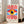 May include: Framed poster with abstract geometric eye design featuring red radiating sunburst lines, large stylized eye with yellow iris and blue pupil on blue background, cream colored frame leaning against white wall next to beige sofa in bright modern living room with large windows