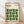 May include: Framed poster with cream background featuring geometric green leaf-like shapes arranged in a repeating pattern. Black text at top reads "BAUHAUS" with subtitle about modernism, minimalism and abstract arts 1919-1933, plus "SCHOOL OF ARCHITECTURE WEIMAR, DESSAU, BERLIN." Natural wood frame leaning against white wall on light wooden floor with soft shadows.