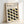 May include: Framed poster with light wood frame leaning against white wall. Print features "BAUHAUS" text at top with "Modernism, minimalism & abstract arts 1919-1933" and "School of Architecture Weimar, Dessau, Berlin" below. Main design shows repeating pattern of leaf-like oval shapes in black, olive green, and muted yellow-green arranged in flowing rows on cream background.