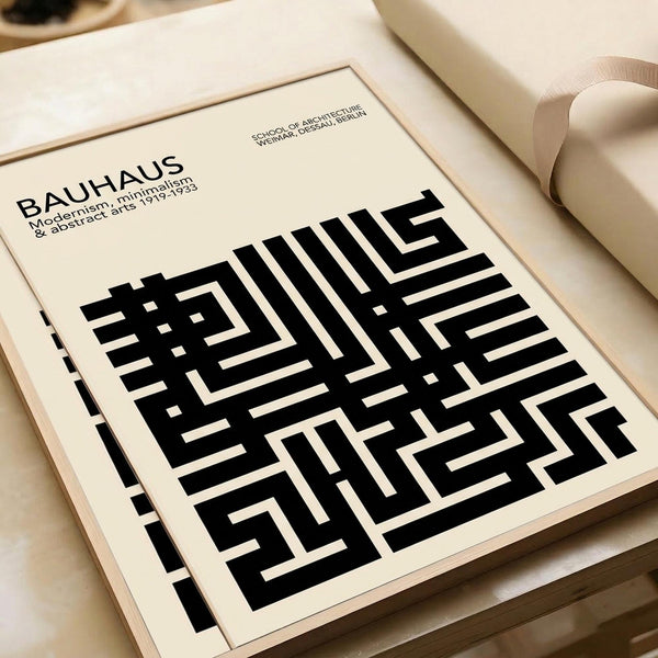 May include: Bauhaus poster print in cream color with bold black geometric maze-like pattern displayed flat on white surface beside rolled paper tubes. The minimalist design features angular interlocking shapes creating an abstract labyrinth effect, with text at top referencing the German design school from 1919-1933. Clean modernist aesthetic with high contrast black and white color scheme.