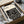 May include: Cream-colored poster with black geometric maze-like pattern and "BAUHAUS" text, displayed in black frame inside cardboard shipping box with white protective foam padding and tissue paper wrapping materials.