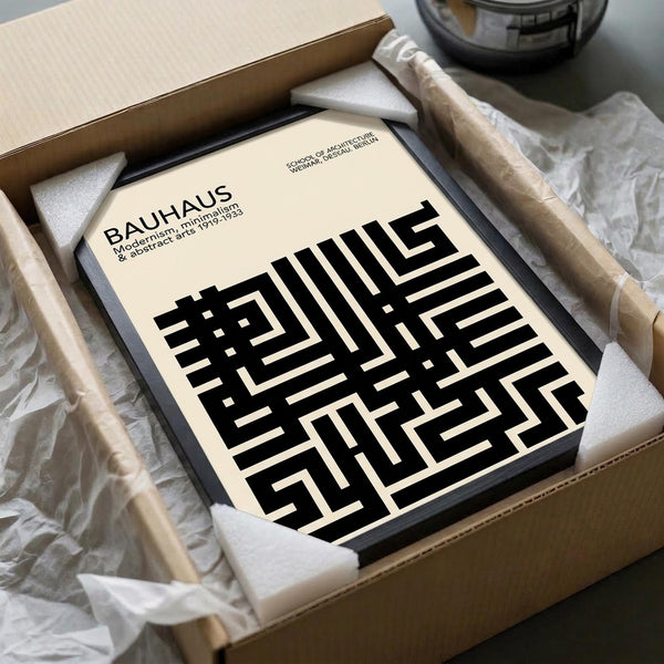 May include: Cream-colored poster with black geometric maze-like pattern and "BAUHAUS" text, displayed in black frame inside cardboard shipping box with white protective foam padding and tissue paper wrapping materials.
