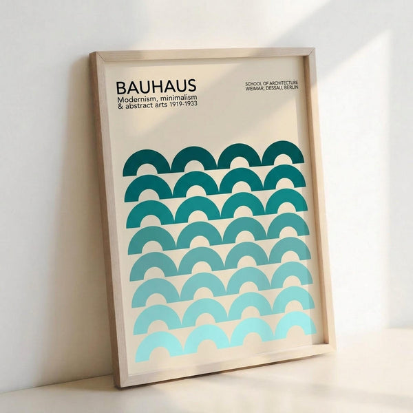 Framed minimalist poster with geometric teal and turquoise half-circle pattern creating wave-like rows. Features "BAUHAUS" text at top with "Modernism, minimalism & abstract arts 1919-1933" and "School of Architecture Weimar, Dessau, Berlin" subtitle. Light wood frame against cream background, displayed leaning on white surface with soft shadow.
