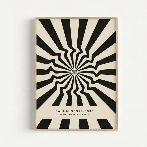 Framed optical illusion poster featuring black and cream radiating stripes that create a wavy, dimensional effect emanating from a central point. Text reads "BAUHAUS 1919-1933 SCHOOL OF ARTS & CRAFTS" in clean typography below the geometric pattern. The print is displayed in a light wood frame against a white wall, showcasing the bold contrast and hypnotic visual movement of the design.