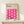 May include: Framed Bauhaus poster with pink wavy geometric pattern displayed on light wood console table against cream wall. The minimalist print features flowing curved shapes creating diamond-like negative spaces on cream background. A small wrapped gift with evergreen sprig sits beside the thin wooden frame.