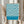 May include: Person holding framed poster with blue and cream wavy optical pattern design in thin light wood frame. Bauhaus exhibition text at bottom in white letters on blue band. Dried pampas grass visible to left, neutral beige clothing and white curtained background create minimalist styling.