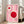 May include: Framed geometric art print with pink background featuring white linear shapes and red circles in Bauhaus style, displayed against white wall next to beige upholstered chair in bright living room with wood floors and large windows