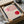 May include: Framed Bauhaus exhibition poster with geometric design featuring pink and red circles with curved line patterns, displayed in black frame inside cardboard shipping box with protective wrapping materials on white surface