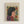 May include: Framed art print featuring a stylized portrait of a woman with dark hair in profile, wearing a red garment with decorative swirls. She's surrounded by colorful flowers in red and blue against a yellow background, rendered in Matisse's characteristic cut-out style. The print has "HENRI MATISSE" text at the top and is displayed in a light wood frame against a white wall.