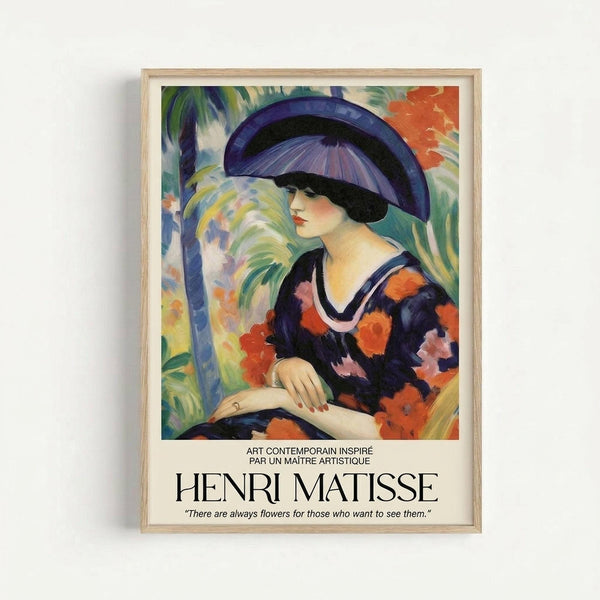 A framed art print featuring a woman in profile wearing a large purple and black hat, dressed in a floral dress with red and pink blooms against navy fabric. She sits in a tropical setting with palm trees and vibrant foliage in greens, blues, and oranges. The painting style shows bold, expressive brushstrokes characteristic of Fauvism. Below the artwork is text reading "ART CONTEMPORAIN INSPIRE PAR UN MAITRE ARTISTIQUE" and "HENRI MATISSE" with a quote about flowers. The print has a ligh