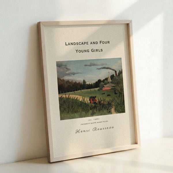 May include: Framed art print in light wood frame leaning against white wall. Print features Henri Rousseau's pastoral landscape painting with four young girls in red dresses walking through green countryside. Scene shows rolling hills, farm buildings with smoking chimney, trees, and cloudy sky. White matting surrounds the colorful artwork with black text above and artist signature below.