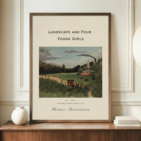 May include: Framed art print of Henri Rousseau's pastoral landscape painting featuring four young girls in red dresses walking through tall grass, with industrial buildings and smokestacks in the background under a cloudy sky. The cream-matted print in a thin brown frame sits on a wooden sideboard next to a small white ceramic vase and stacked books against white wainscoting.