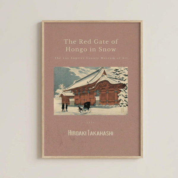 May include: Framed vintage Japanese woodblock print showing a traditional temple building with snow-covered roof and trees. The artwork features muted earth tones on a dusty rose background with cream text above and below the image. A horse-drawn cart and figures are visible in the snowy courtyard scene. The print is displayed in a thin wooden frame against a light gray wall.