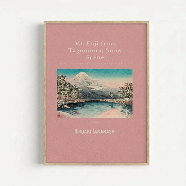 Framed vintage Japanese woodblock print poster featuring Mount Fuji with snow-covered peak rising behind a serene lake scene. The artwork shows traditional ukiyo-e style with turquoise sky, dark forested hills, and reflective water in the foreground. Pink matted background displays white text including the artwork title and artist name "Hiroaki Takahashi." Light wooden frame against white wall.