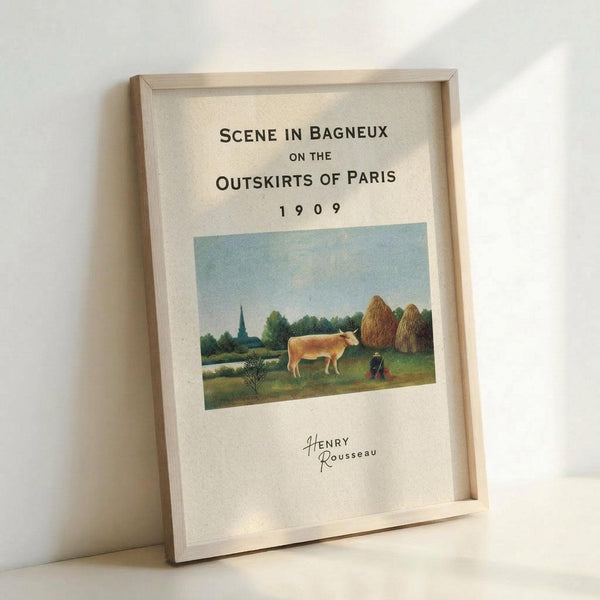 May include: Framed poster print featuring Henri Rousseau's pastoral painting of a rural French countryside scene with a brown cow, hay stacks, church spire, and figure in a field under blue sky. The cream-colored print displays black text reading "Scene in Bagneux on the Outskirts of Paris 1909" above the artwork and "Henry Rousseau" signature below. Light wood frame leans against white wall, showing realistic room display mockup with natural lighting and shadows.