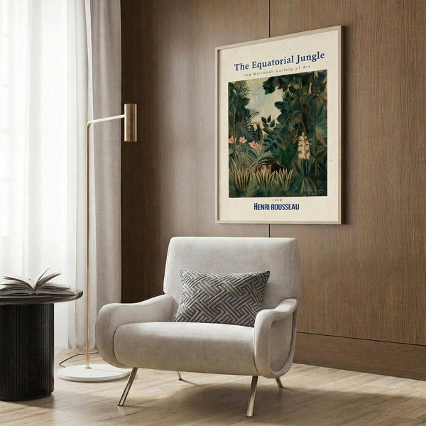 May include: Framed poster of tropical jungle scene with lush green foliage, palm fronds, and exotic plants displayed on wood-paneled wall above beige upholstered armchair with geometric patterned pillow. Modern brass floor lamp and small round table with open book complete the warm, contemporary reading nook setting.