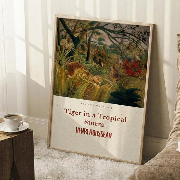 May include: Framed art print leaning against white wall showing dense jungle scene with lush green foliage, tropical plants, and hidden tiger among the vegetation. Natural wood frame with white matting displays the title and artist name below the colorful botanical artwork. Scene includes wooden side table with white coffee cup, cream textured rug, and soft natural lighting creating window shadows on the wall.