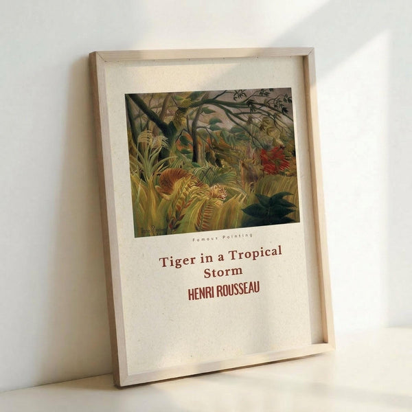 May include: Framed art print featuring Henri Rousseau's tropical jungle scene with a tiger hidden among lush green foliage, displayed in a light wooden frame against a white wall. The poster shows dense vegetation with various shades of green leaves and plants, with red text below identifying the artwork and artist. Natural lighting creates soft shadows on the minimalist white background.