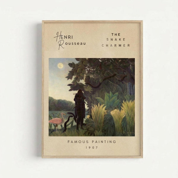 A framed art print featuring Henri Rousseau's jungle painting with a silhouetted figure among lush tropical foliage, pink flamingos, and moonlit sky. The print has cream-colored matting with black text reading "HENRI ROUSSEAU," "THE SNAKE CHARMER," "FAMOUS PAINTING," and "1907." The light wood frame is displayed against a white wall, casting a subtle shadow.