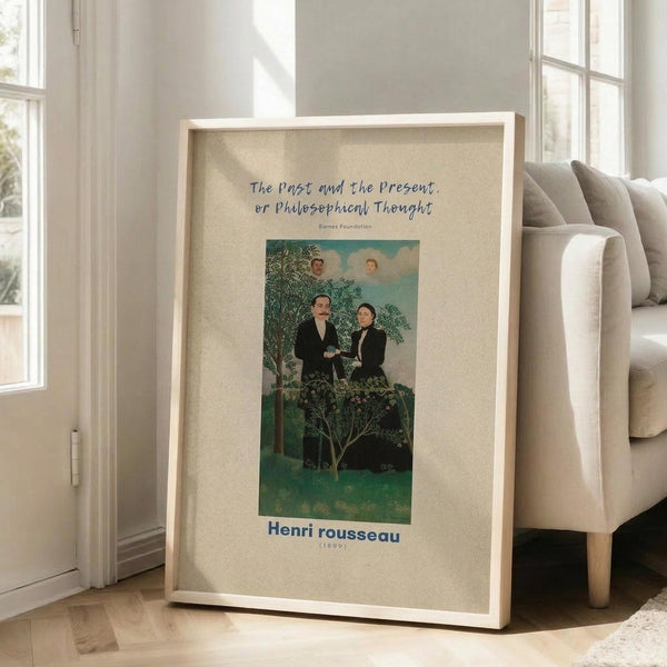 May include: A framed art print leaning against a white wall next to a beige upholstered chair in a bright room with large windows. The poster features a surreal painting with two men in dark suits shaking hands among lush green trees, with two portrait heads floating in a blue sky above. The artwork has vivid greens and blues with a dreamlike quality. Text appears at the top and bottom of the cream-colored poster in a light wooden frame.
