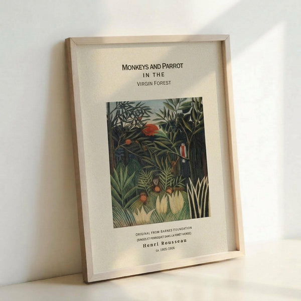 May include: Framed art print leaning against white wall showing Henri Rousseau's jungle painting with monkeys and a red parrot among dense green tropical foliage. Light wood frame with white matting displays the vintage botanical artwork with museum-style text labels above and below the image.