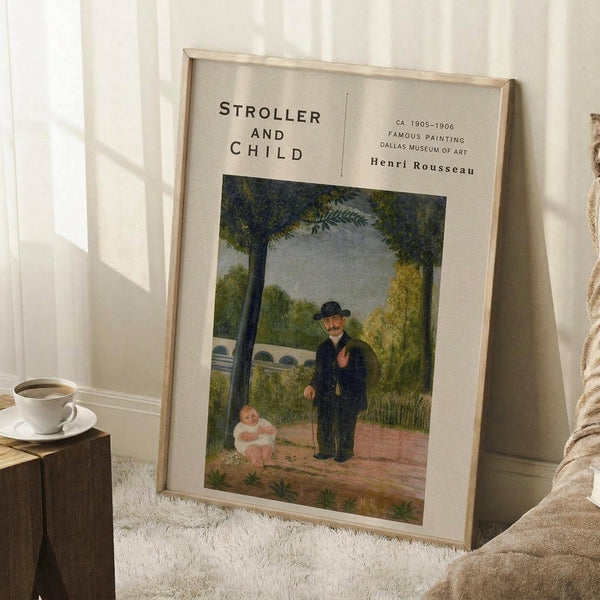 May include: Framed art print leaning against white paneled wall on textured cream rug. Print shows naive-style painting of man in dark suit and bowler hat standing next to small child in white dress in park setting with green trees. Museum-style layout with beige matting and thin wooden frame. Coffee cup on wooden block nearby.