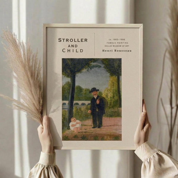 May include: Hands holding a framed art print of Henri Rousseau's painting showing a man in dark clothing and hat standing next to a small child in white on a tree-lined path. The poster has cream matting with black text reading "STROLLER AND CHILD" and museum details. One hand also holds dried wheat stalks against a soft neutral background with window light.