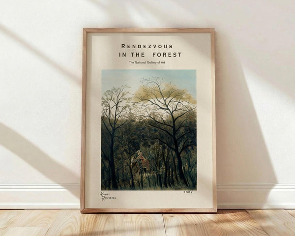 May include: A framed art print leaning against a white wall on light wood flooring. The poster features a lush forest scene with tall trees creating a canopy, painted in muted greens and earth tones with a pale blue sky visible through the branches. The artwork has a dreamlike, primitive style showing dense jungle vegetation. Text at the top reads "Rendezvous in the Forest" and "The National Gallery of Art" with the artist name and date "1889" at the bottom. The print is displ