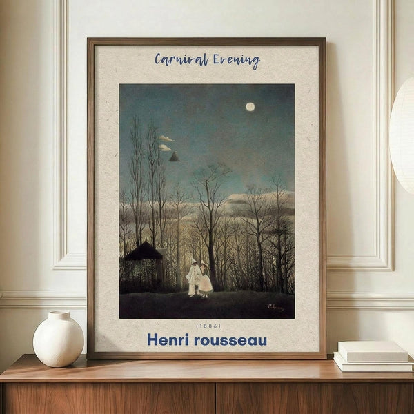 May include: Framed art print displaying a moonlit evening scene with bare trees, two figures in white and pink clothing, and a small dark building under a pale full moon. The poster has a cream-colored mat with blue text reading "Carnival Evening" at top, "(1886)" in middle, and "Henri rousseau" at bottom. Wooden frame sits on light wood surface beside white ceramic vase and stacked books against cream paneled wall.