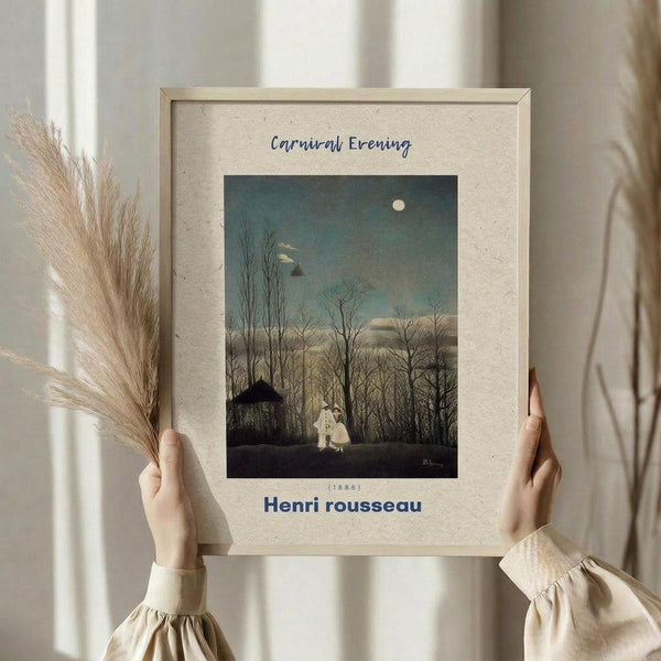 May include: Person in cream clothing holding framed art print against white curtained window, with dried pampas grass in other hand. The vintage-style poster shows a moonlit evening scene with bare trees, small house, and two figures in white costumes walking on a path. Features muted blue-green sky, cream matting, and light wooden frame.