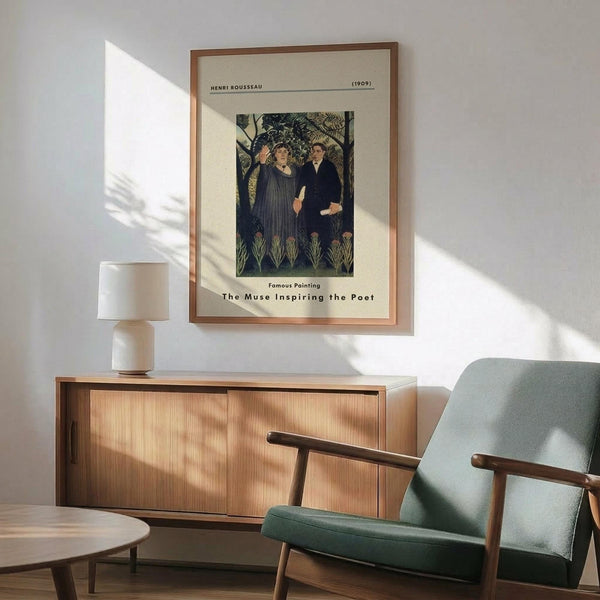 May include: Framed vintage art poster featuring Henri Rousseau's 1909 painting "The Muse Inspiring the Poet" showing two figures in a lush jungle setting. Poster has cream matting with brown frame, displayed above wood sideboard with white ceramic lamp. Mid-century mint green upholstered armchair with wooden frame sits nearby on hardwood floor. Bright natural sunlight creates dramatic shadows across white wall.