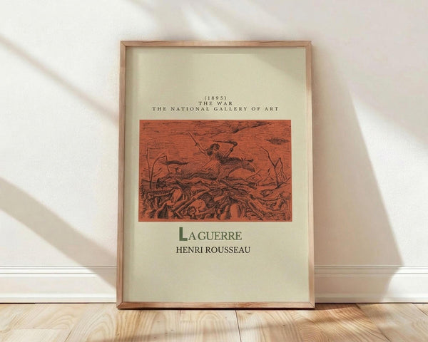 May include: Framed vintage art poster featuring Henri Rousseau's "La Guerre" (1895) from The National Gallery of Art. The print shows a dark figure on horseback amid reddish-orange tones in an apocalyptic war scene. Natural wood frame with cream matting, leaning against white wall on light wooden floors with soft natural lighting casting diagonal shadows.