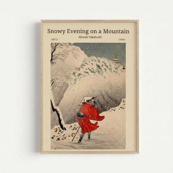 Japanese woodblock print showing a figure in flowing red robes walking through heavy snowfall on a mountain path. Snow-covered rocky cliffs and bare tree branches frame the scene against a dark gray sky filled with falling snow. The artwork is displayed in a light wooden frame with cream matting, featuring the title and artist's name at the top. Muted earth tones with vibrant red accent create a serene winter landscape in traditional ukiyo-e style.
