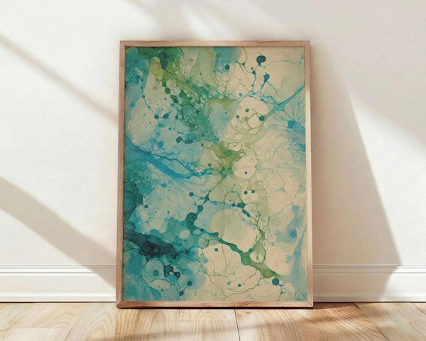 May include: Abstract artwork in wooden frame leaning against white wall on light wood floor. Flowing organic shapes in teal, turquoise, sage green and cream colors with scattered circular dots connected by delicate branching lines. Fluid watercolor-style textures blend from deep emerald to pale yellow-green. Natural lighting creates soft shadows on textured white fabric backdrop.