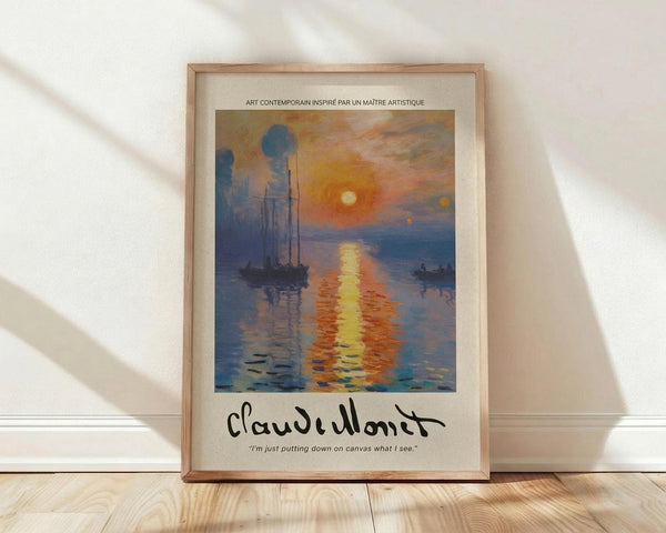 May include: Framed poster print of Monet's Impression, Sunrise showing boats silhouetted against orange sunset reflecting on blue water. Print features French text at top, Monet's signature and quote at bottom. Light wood frame with cream matting, displayed on wooden floor against white wall with soft natural lighting creating diagonal shadows.