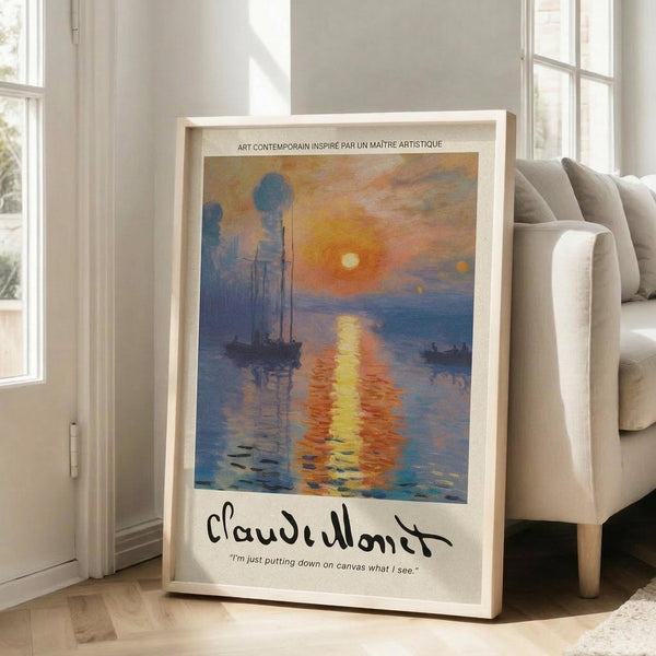 May include: Framed poster print of Impressionist-style harbor scene at sunrise with sailing ships silhouetted against orange and yellow sky reflecting on blue water, displayed in light wood frame on floor beside beige sofa in bright modern living room with white walls and large windows