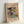 May include: Framed art print featuring Wassily Kandinsky's abstract painting with vibrant swirling colors including blues, yellows, reds, and teals. The poster shows geometric and organic shapes with dynamic brushstrokes. Text reads "Improvisation No. 30" and "The Art Institute of Chicago" above the artwork, with "Wassily Kandinsky" below. Light wood frame against white wall, leaning on surface with soft natural lighting creating gentle shadows.