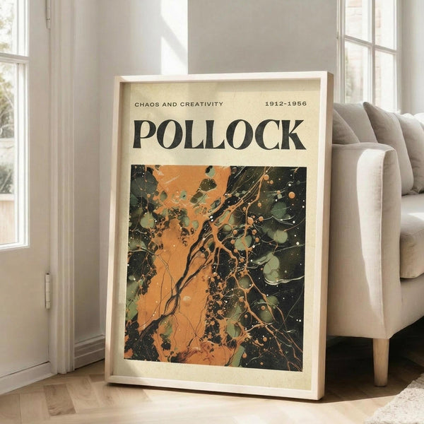 May include: Framed art poster with "POLLOCK" text and "CHAOS AND CREATIVITY 1912-1956" header above abstract painting featuring orange, green, and black paint splatters and drips. Wooden frame leans against white wall next to beige upholstered chair in bright room with large windows and hardwood floors.
